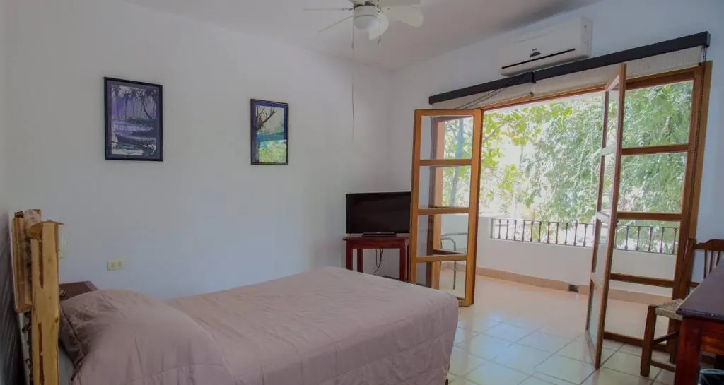 Guest room opening toward a balcony